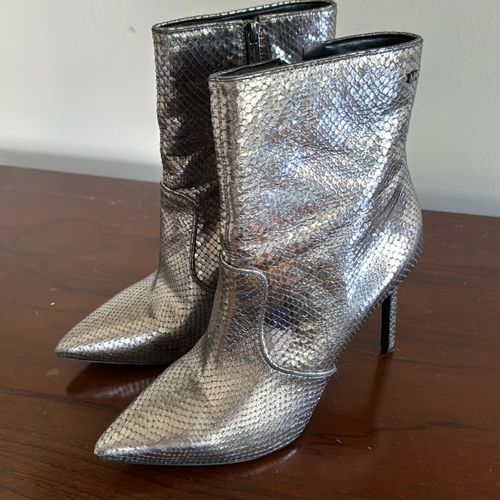 High silver Michael Kors zip up ankle booties.